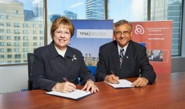 Janet Ecker, President and CEO of the Toronto Financial Services Alliance, and Dr. Tom Corr, President and CEO of Ontario Centres of Excellence, sign a new partnership agreement that will connect Toronto's financial services sector with Ontario's innovation ecosystem.