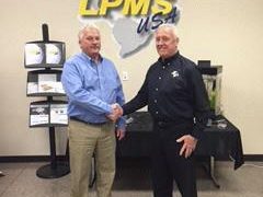 Tom Charlton, president of Electronic Coating Technologies shakes hands with Mike Cooper, president of LPMS-USA.