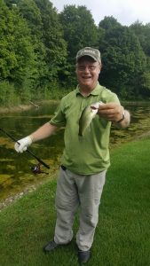 Known for his expertise in the boat fishing, as opposed to on the golf course, Tom Luke, Weiss Co, made his biggest contribution to his foursome on the local pond. He is seen here with his biggest catch of the day.